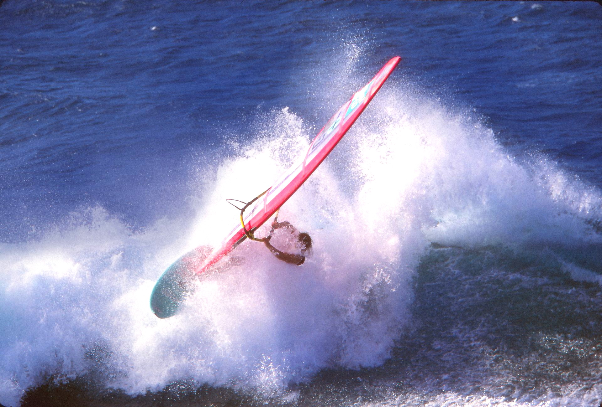 1990s archive, archive grade — a windsurfer thrown clear of a breaking wave on a pink Chiemsee board
